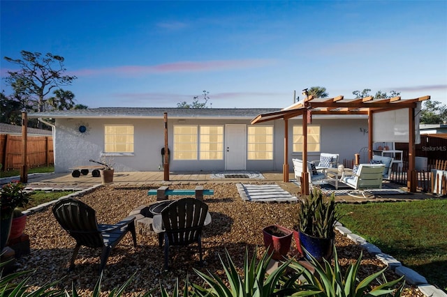 back house at dusk featuring an outdoor living space, a patio, and a pergola