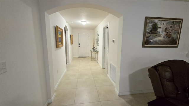 corridor featuring light tile patterned floors