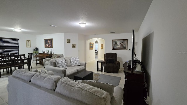 tiled living room with a textured ceiling