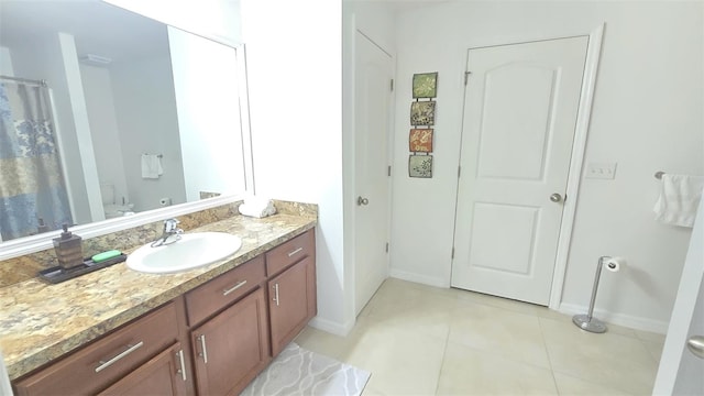 bathroom with vanity, tile patterned flooring, and toilet