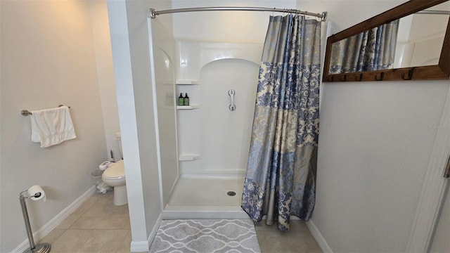 bathroom featuring tile patterned floors, toilet, and walk in shower