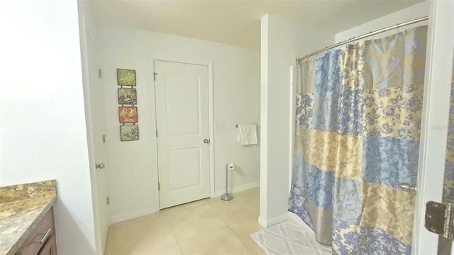 bathroom with tile patterned flooring, vanity, and curtained shower