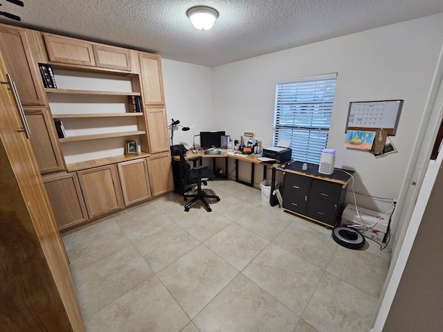 office with a textured ceiling and light tile patterned flooring