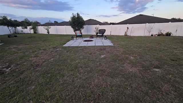 yard at dusk featuring a patio area