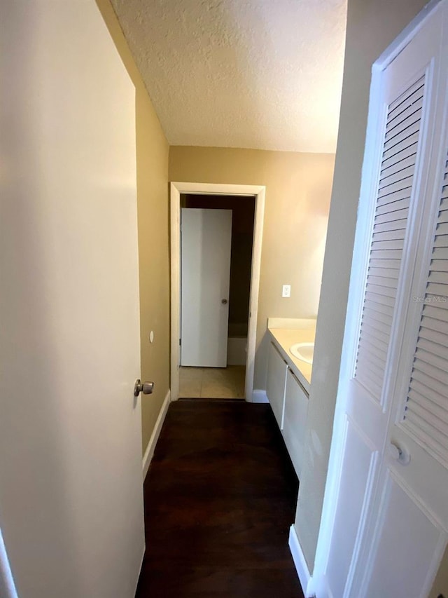 516 Orange Dr Unit 17, Altamonte Springs, FL 32701 - hall with a textured ceiling, dark wood-type flooring, and baseboards