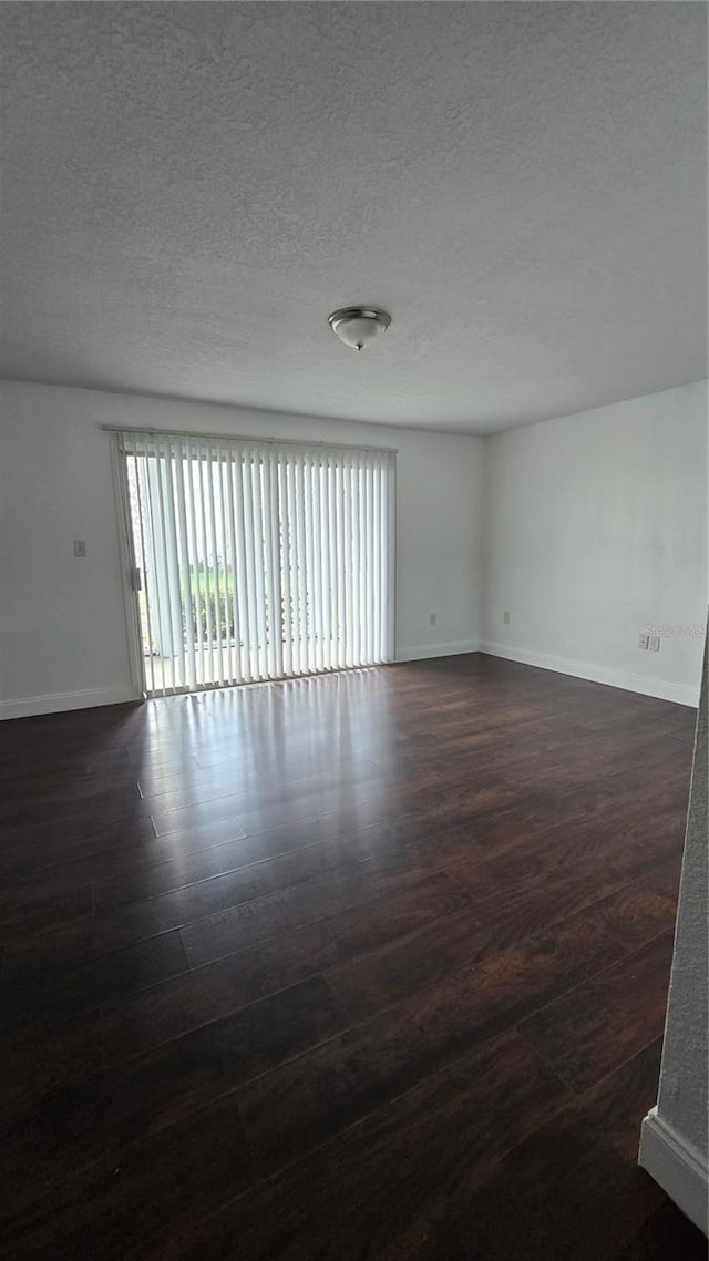 516 Orange Dr Unit 17, Altamonte Springs, FL 32701 - empty room with baseboards, dark wood finished floors, and a textured ceiling