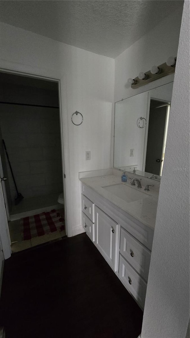 516 Orange Dr Unit 17, Altamonte Springs, FL 32701 - bathroom featuring a textured ceiling, toilet, and vanity