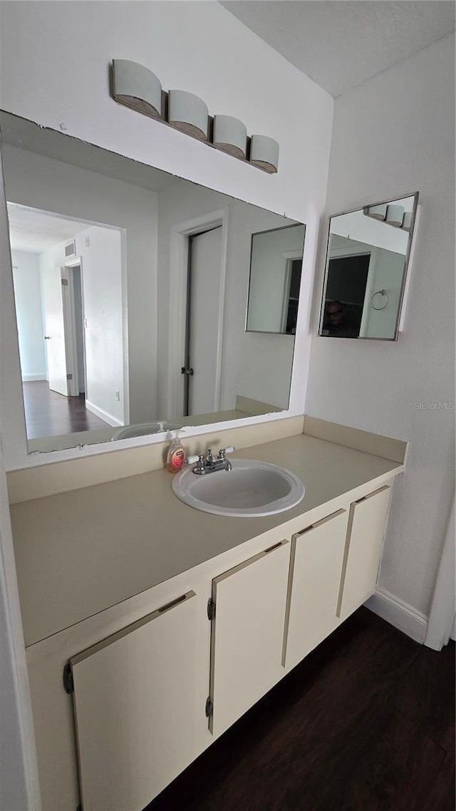 516 Orange Dr Unit 17, Altamonte Springs, FL 32701 - bathroom featuring vanity, baseboards, and wood finished floors