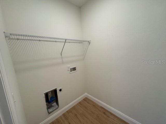 laundry room featuring hardwood / wood-style floors, hookup for a washing machine, and hookup for an electric dryer