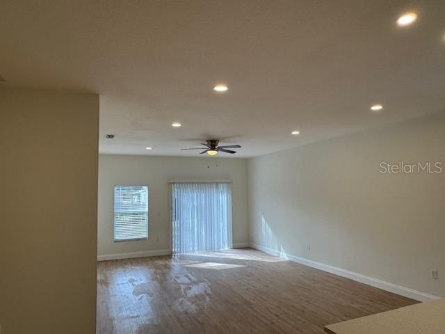 unfurnished room featuring hardwood / wood-style flooring and ceiling fan