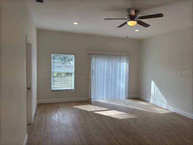 spare room featuring ceiling fan and light wood-type flooring