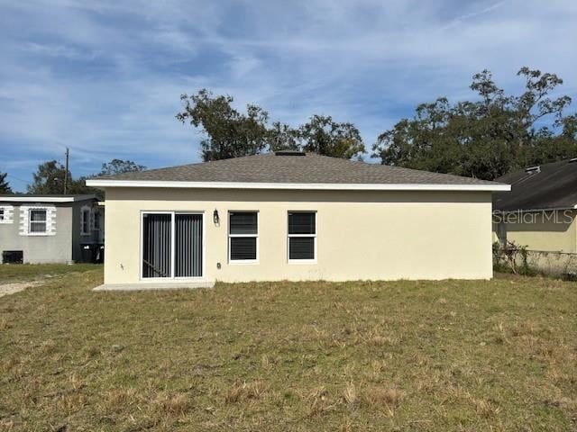 rear view of house with a yard