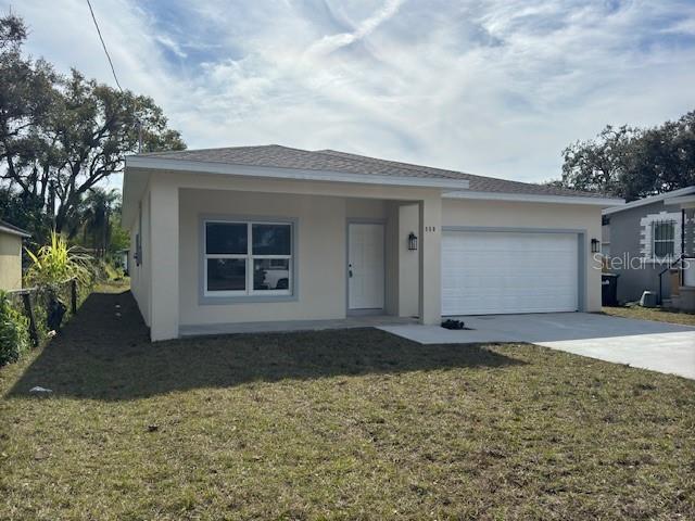 view of front of house featuring a garage and a front lawn