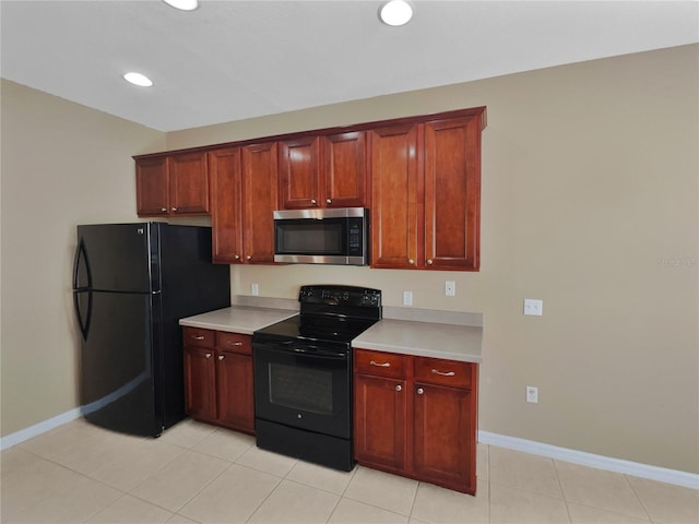kitchen with light tile patterned flooring and black appliances