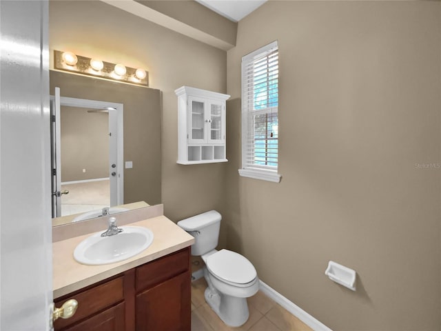 bathroom featuring vanity, toilet, and tile patterned flooring