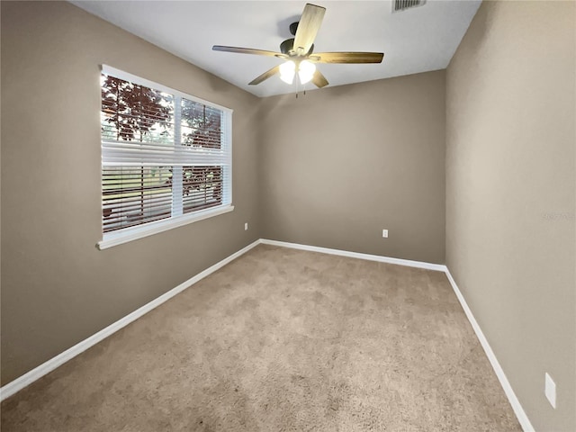 empty room featuring light carpet and ceiling fan