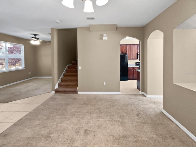 interior space featuring ceiling fan and light carpet