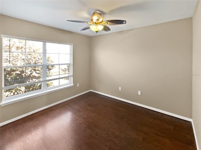 empty room featuring ceiling fan and dark hardwood / wood-style flooring