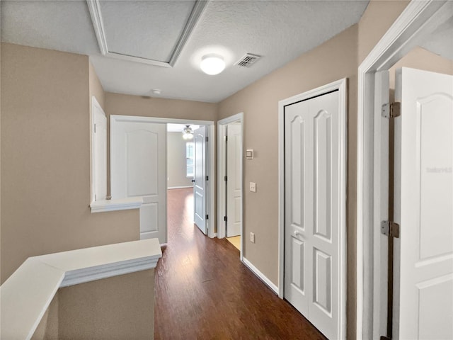 corridor with dark hardwood / wood-style flooring