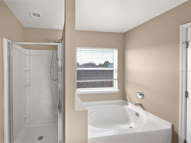 bathroom featuring separate shower and tub