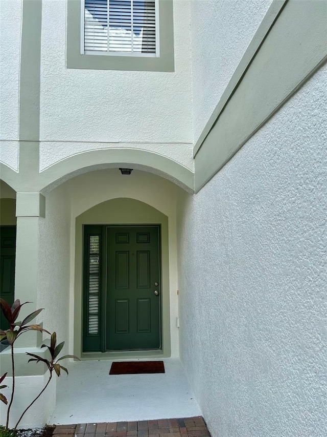 6912 Hochad Dr, Orlando, FL 32819 - doorway to property with stucco siding