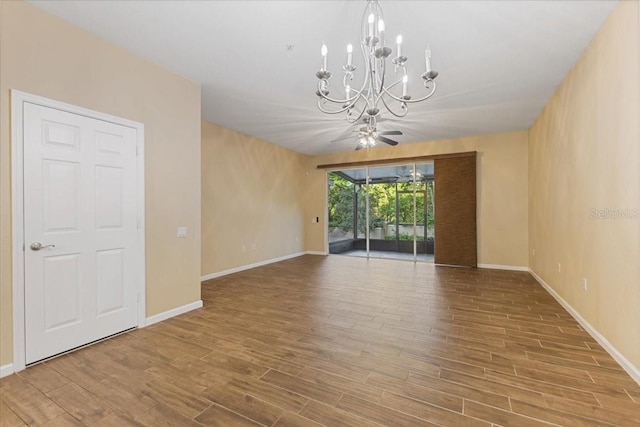 6912 Hochad Dr, Orlando, FL 32819 - empty room featuring a chandelier, wood finished floors, and a ceiling fan