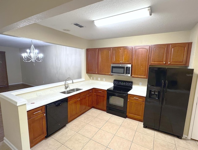 6912 Hochad Dr, Orlando, FL 32819 - kitchen featuring black appliances, a peninsula, light countertops, a chandelier, and brown cabinetry