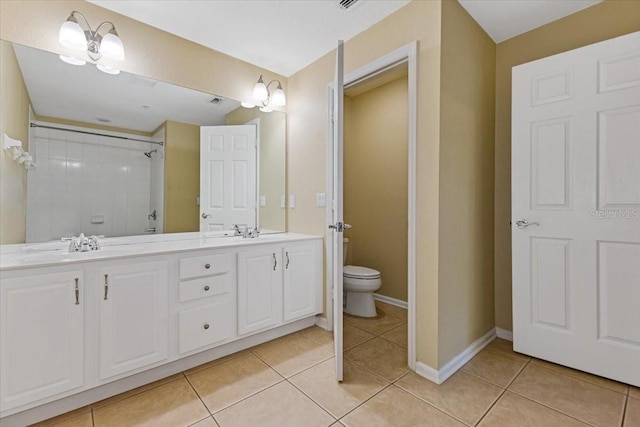 6912 Hochad Dr, Orlando, FL 32819 - full bathroom with double vanity, tile patterned floors, and a tile shower