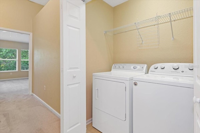 6912 Hochad Dr, Orlando, FL 32819 - laundry area featuring washer and dryer and light colored carpet