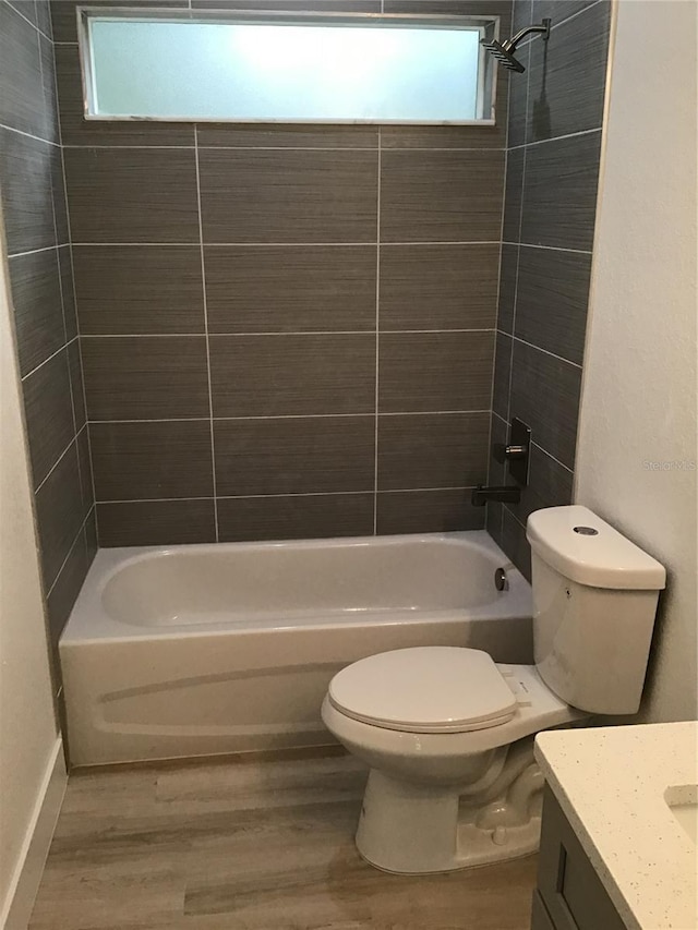 6915 SE 23rd Ave, Ocala, FL 34480 - full bathroom with vanity, wood-type flooring, toilet, and tiled shower / bath
