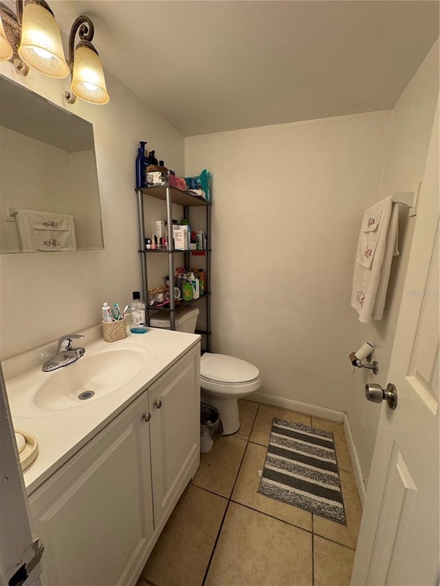 bathroom featuring tile patterned flooring, vanity, and toilet