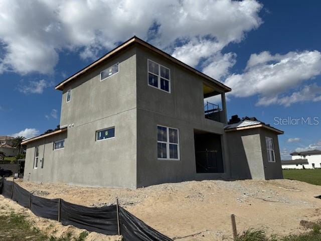 back of property featuring a balcony