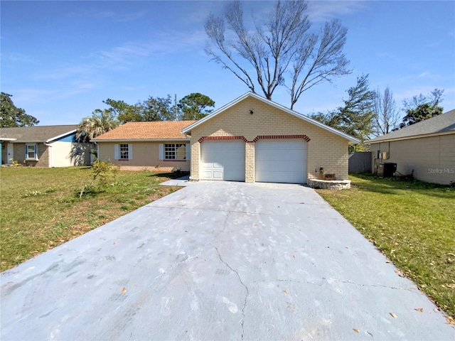 single story home with a garage, a front yard, and central air condition unit