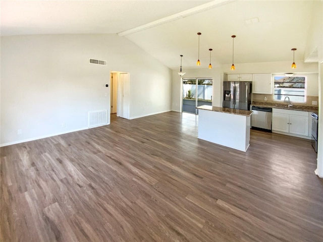 kitchen featuring a kitchen island, decorative light fixtures, white cabinets, stainless steel appliances, and a healthy amount of sunlight