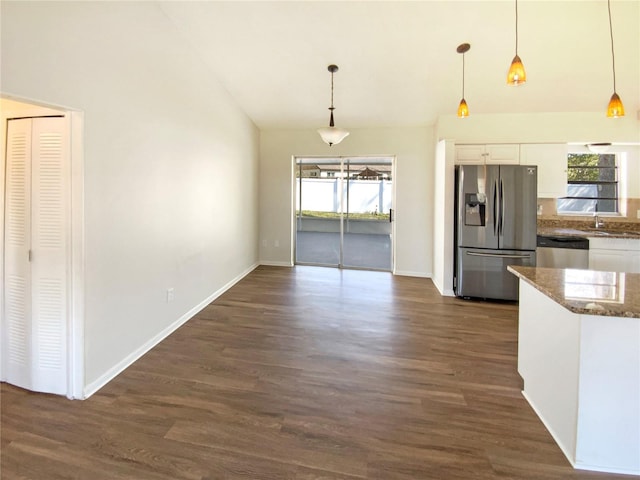 kitchen featuring appliances with stainless steel finishes, dark wood-type flooring, pendant lighting, and white cabinets