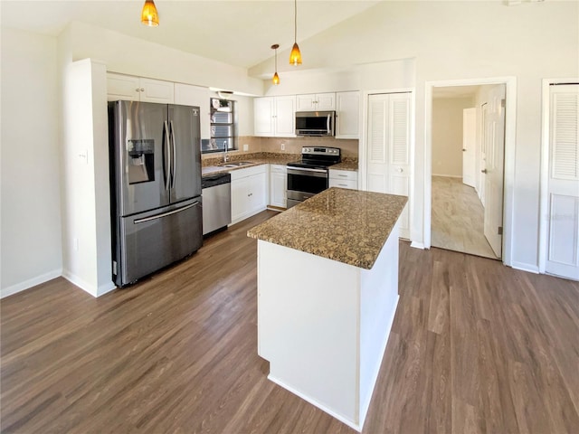 kitchen with a kitchen island, appliances with stainless steel finishes, sink, white cabinets, and hanging light fixtures