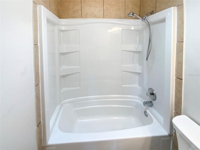 bathroom featuring shower / bath combination and toilet