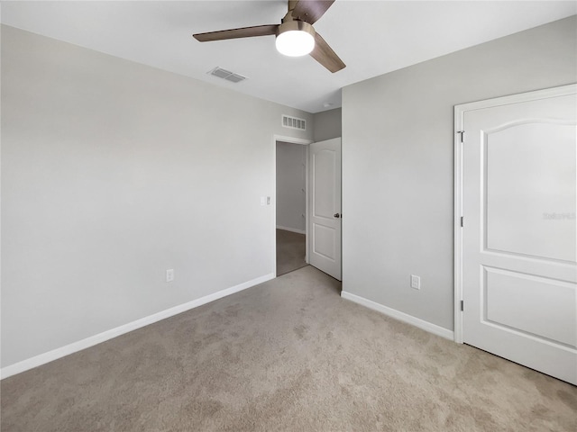 unfurnished bedroom featuring ceiling fan and light colored carpet