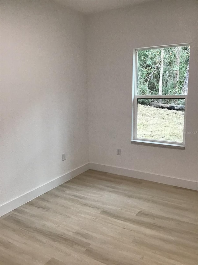 spare room with light hardwood / wood-style floors