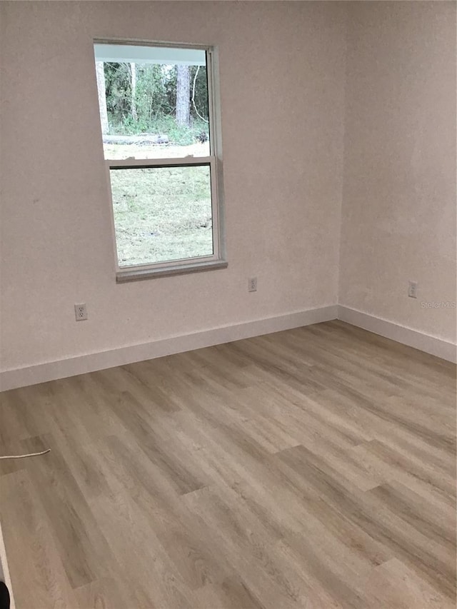 spare room with light wood-type flooring