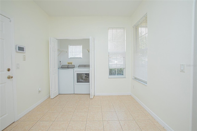 washroom featuring washing machine and dryer and light tile patterned floors