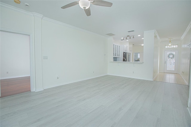 unfurnished living room with crown molding, ceiling fan, and light wood-type flooring