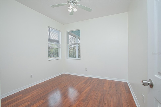 empty room with dark hardwood / wood-style floors and ceiling fan