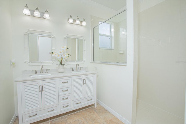 bathroom with vanity, tiled shower, and ornamental molding