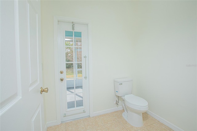 bathroom featuring toilet and tile patterned flooring