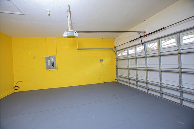 garage with a garage door opener and electric panel