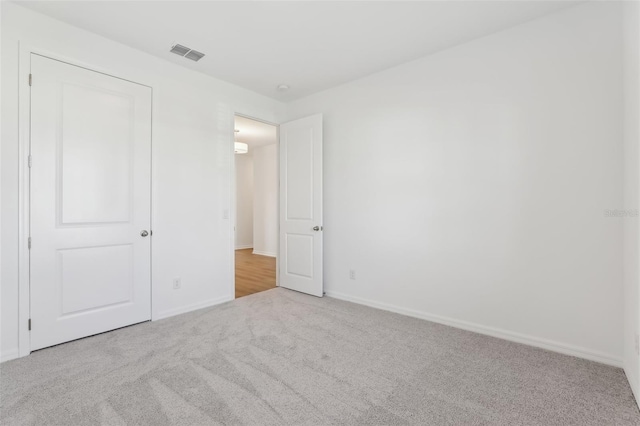 unfurnished bedroom featuring light carpet