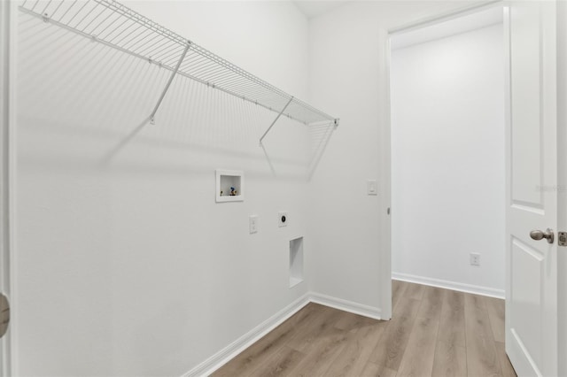 washroom with hookup for a washing machine, hookup for an electric dryer, and light hardwood / wood-style floors