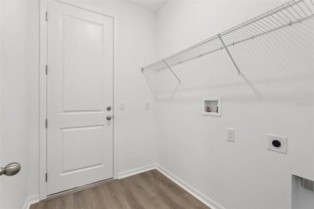 clothes washing area with hardwood / wood-style floors, hookup for a washing machine, and hookup for an electric dryer