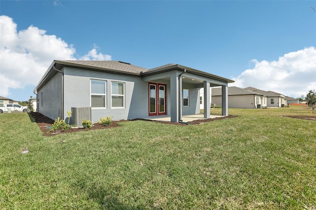 back of house with a yard, cooling unit, and a patio area